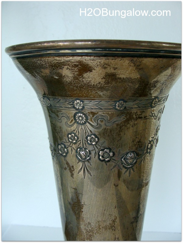 close up of tarnished antique silver vase