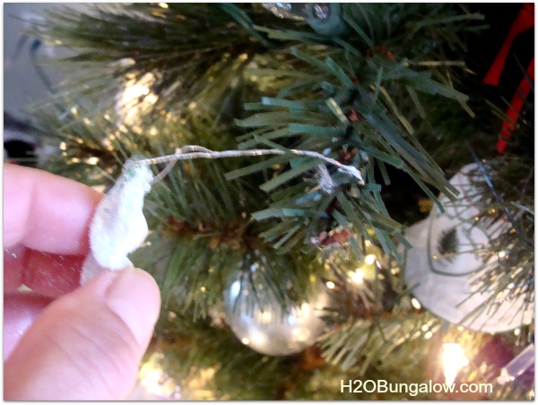 wind ornaments on the tips of the christmas tree branches