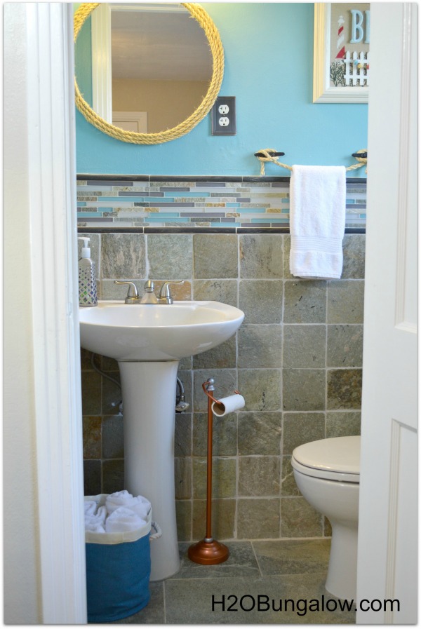 Beachy coastal bathroom makeover that is anything but boring. From the copper tissue holder to the boat cleat towel holder this bath is unique and fun. You won't believe the before! www.H2OBungalow.com