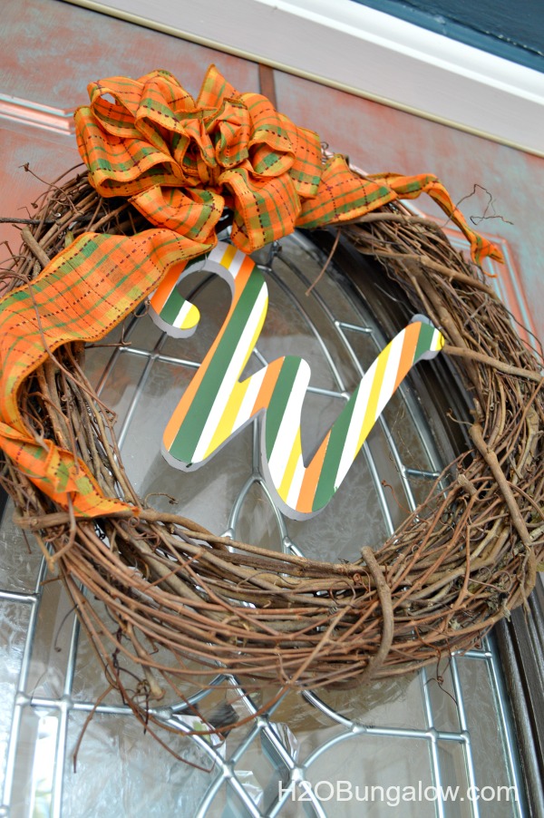 Fall grapevine wreath with orange plaid bow and the letter W in the middle
