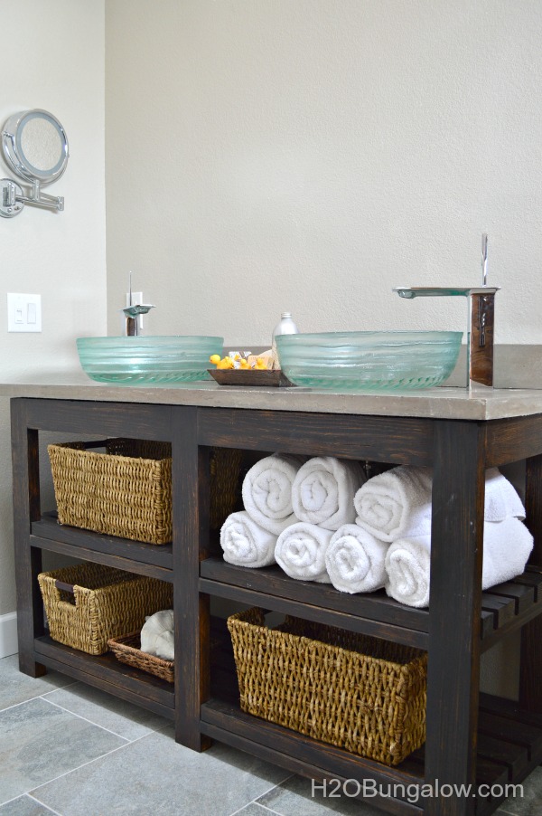 I built my own DIY Vanity with open shelves for about $100. You can too! Download my free plans. This woud also make an awesome kitchen island! www.H2OBungalow.com #woodworking #freebuildplans # buildit