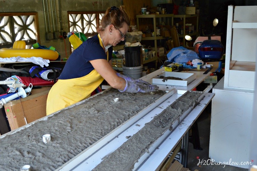 Patting the wet concrete for DIY concrete counter top 