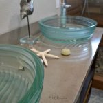 DIY concrete countertop with two glass vessel sinks