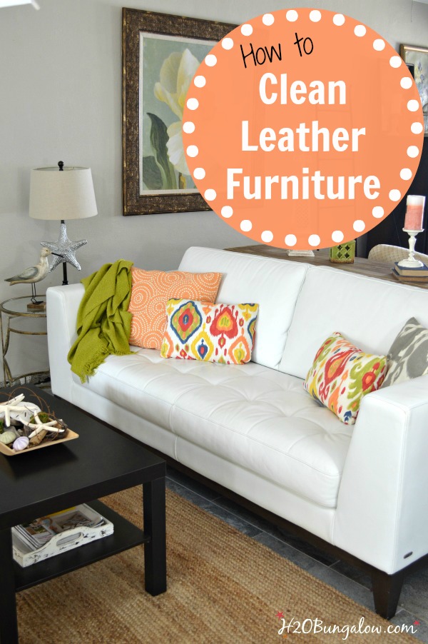 White leather sofa with throw pillows and coffee table