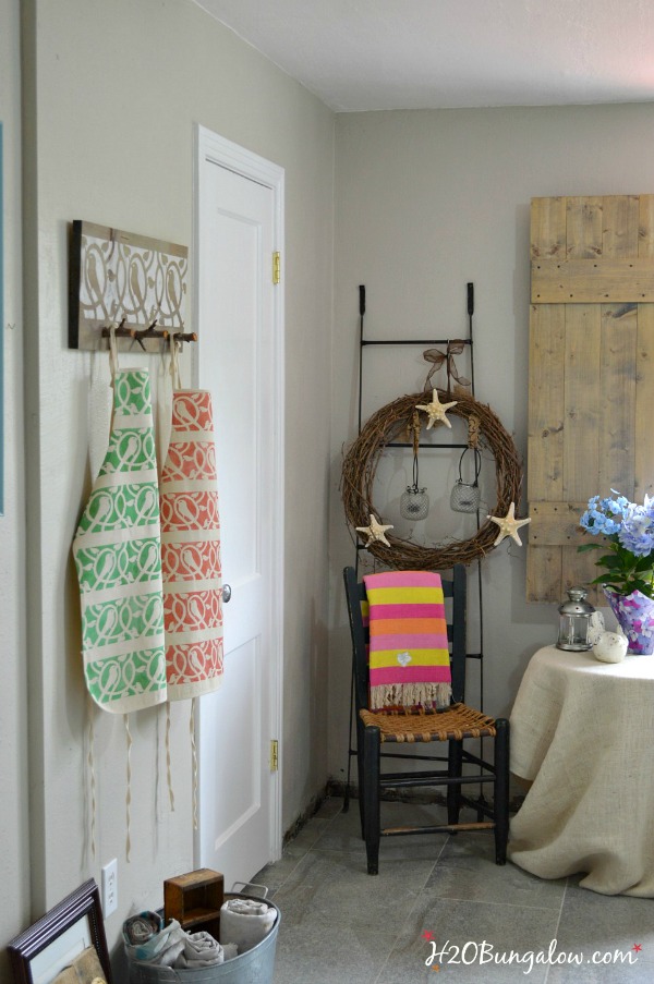 Stenciled-coat-rack-made-with-twig-branches-H2OBungalow