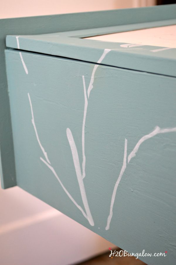 layered bird stencils on my bathroom storage cabinet makeover with frosted glass inserts H2OBungalow