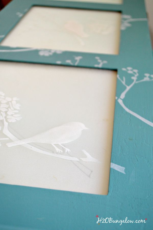 layered bird stencils on my bathroom storage cabinet makeover with frosted glass inserts H2OBungalow