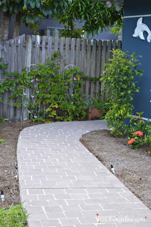 Simple faux painted paver projects transforms a plain concrete area in a few hours. Simple tutorial with video included. www.H2OBungalow.com #paintedconcrete #homeimprovement 