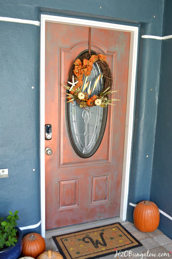 Make a simple and festive monogram fall wreath with starfish, acorns and pumkins. Tuck sprigs of greenery into the grapevine wreath for filler. See this and 30 more fall projects in the Fall Ideas Tour. www.H2OBungalow.com #Fallwreath "Falldecor #FallIdeasTour
