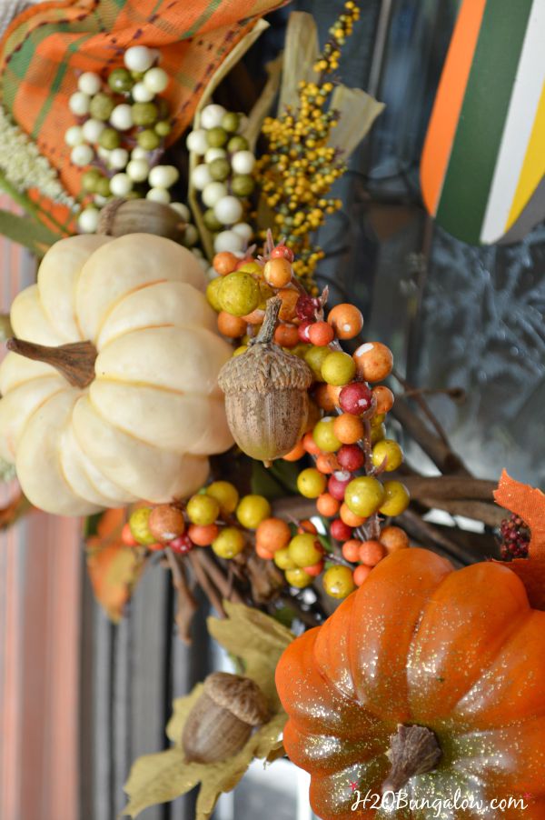 Make a simple and festive monogram fall wreath with starfish, acorns and pumkins. Tuck sprigs of greenery into the grapevine wreath for filler. See this and 30 more fall projects in the Fall Ideas Tour. www.H2OBungalow.com #Fallwreath "Falldecor #FallIdeasTour