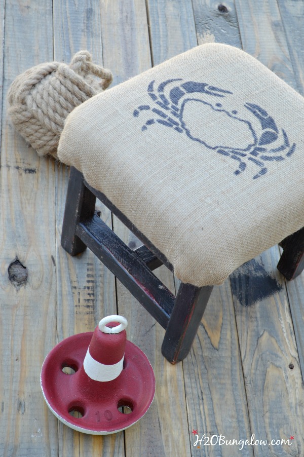 DIY coastal burlap footstool with crab graphic. Easy tutorial to cushion something in burlap and add a graphic. Linked to Themed Furniture Makeover Day and many more black furniture makeovers www.H2OBungalow.com #paintedfurniture