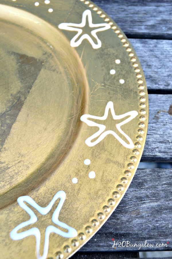 Upcycle old chargers with a fun design, paint and seal to add interest to your holiday tablescape. H2OBungalow.com #tablescape