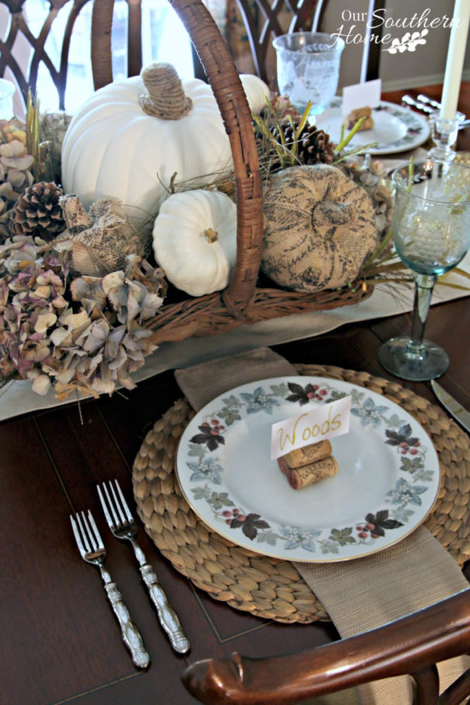 wicker basket filled with pumpkins and natural fall florals