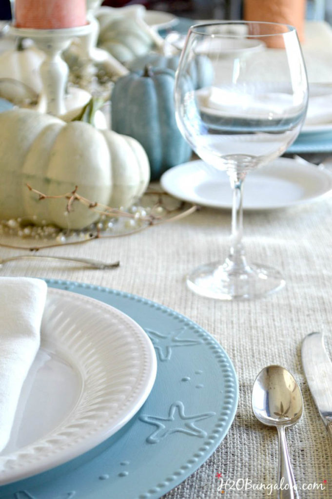 blue starfish charger with white plate and napkin table setting