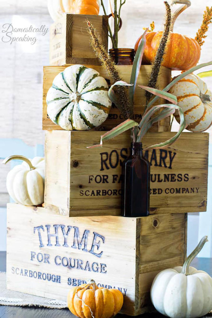 wooden boxes stacked on top of each other with small pumpkins