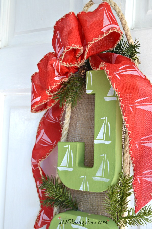 Nautical sailboat Christmas wreath puts a new twist on a coastal themed wreath for the holidays. I love indoor or on the front door! H2OBungalow