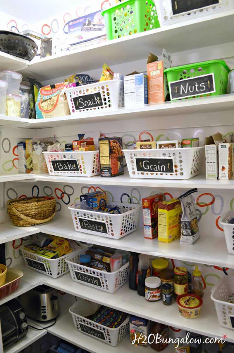 pantry shelves with organizing bins and canned and boxed food