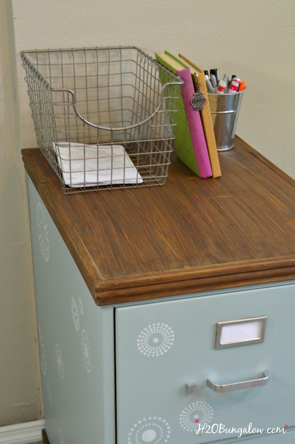 Use a thrift store cast off for this project. DIY tutorial for upcycled painted and stenciled filing cabinet makeover with stained wood top and bottom. Add style to your office a budget. H2OBunglow.com 