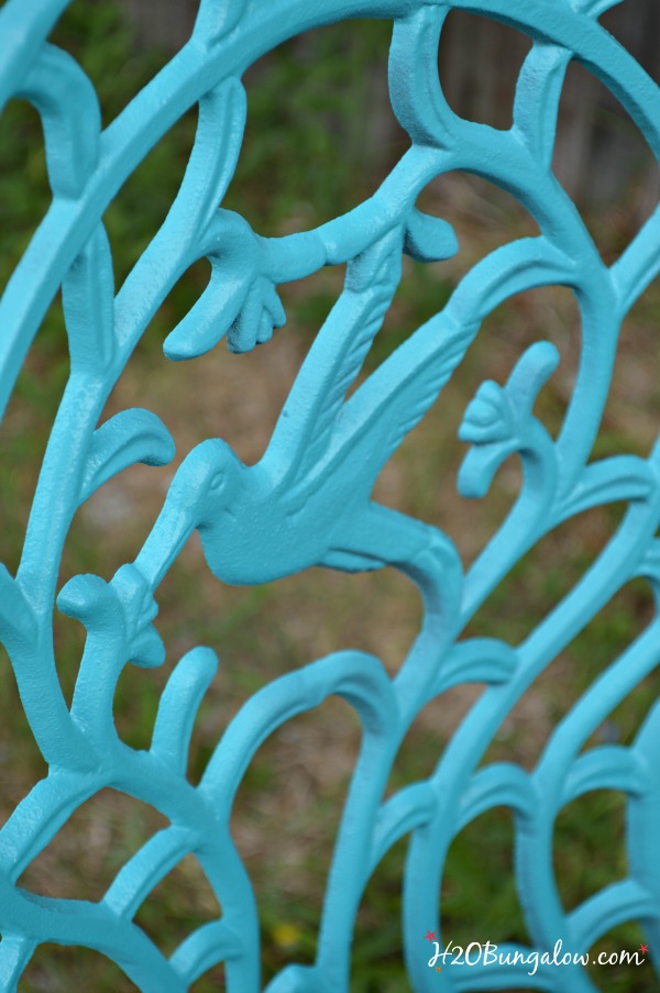 Close up of back of metal chair spray painted turquoise