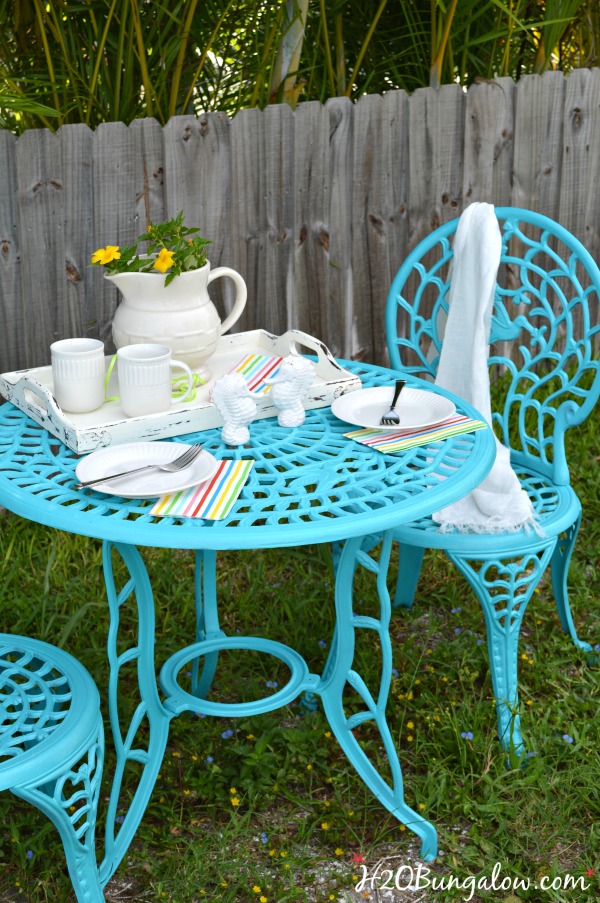 Outdoor metal table and chair set spray painted turquoise with table settings for two