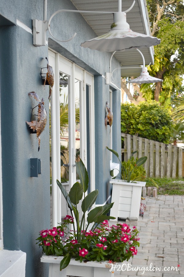 side view of blue house with white trim and metal turtles