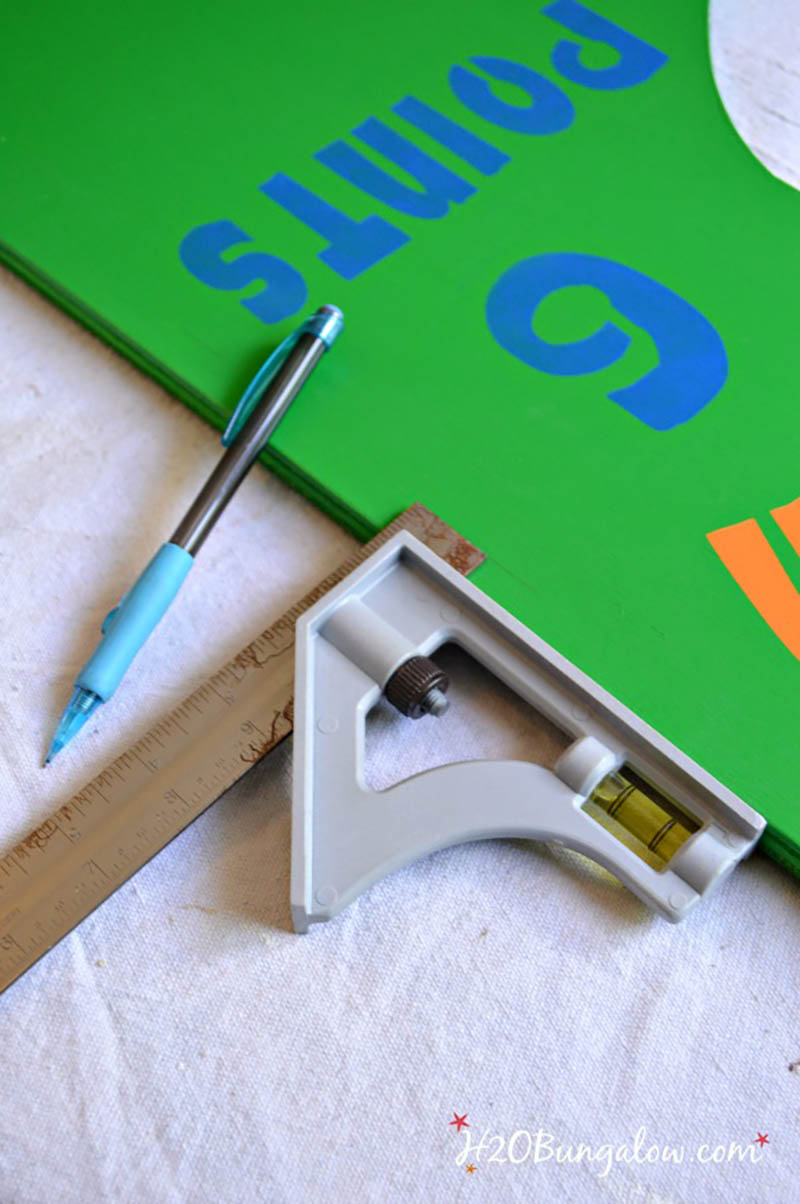 striping board of DIY football toss game with t-square and pencil