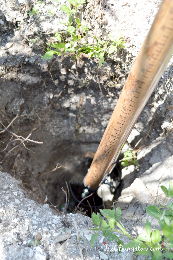 ditch digger in the hole for the DIY hammock stand posts