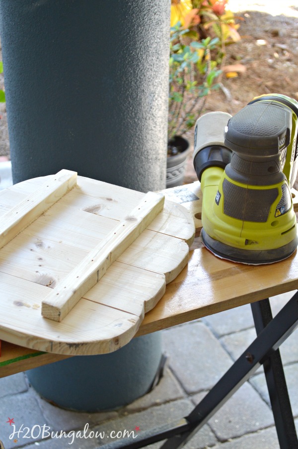 back side of wood pumpkin and orbital sander 