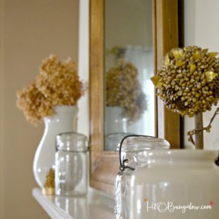 Get the Restoration Hardware look for less. Tutorial to remove veneer from wood on an old mirror exposing a natural wood patina and deconstructed style.