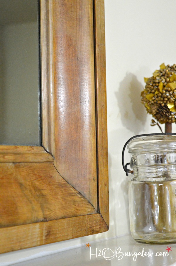 Get the Restoration Hardware look for less. Tutorial to remove veneer from wood on an old mirror exposing a natural wood patina and deconstructed style.