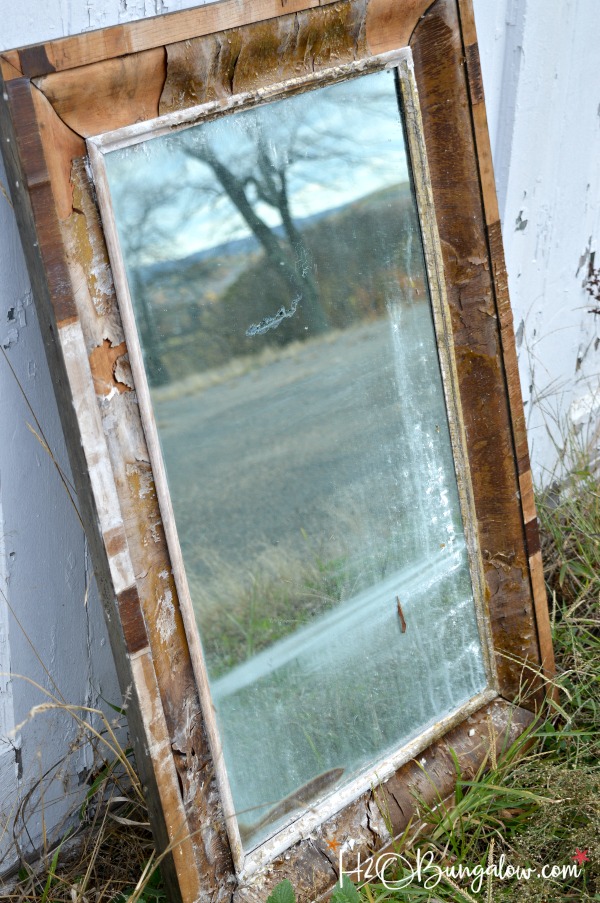 Get the Restoration Hardware look for less. Tutorial to remove veneer from wood on an old mirror exposing a natural wood patina and deconstructed style.