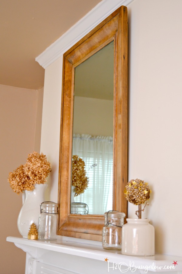 Get the Restoration Hardware look for less. Tutorial to remove veneer from wood on an old mirror exposing a natural wood patina and deconstructed style.