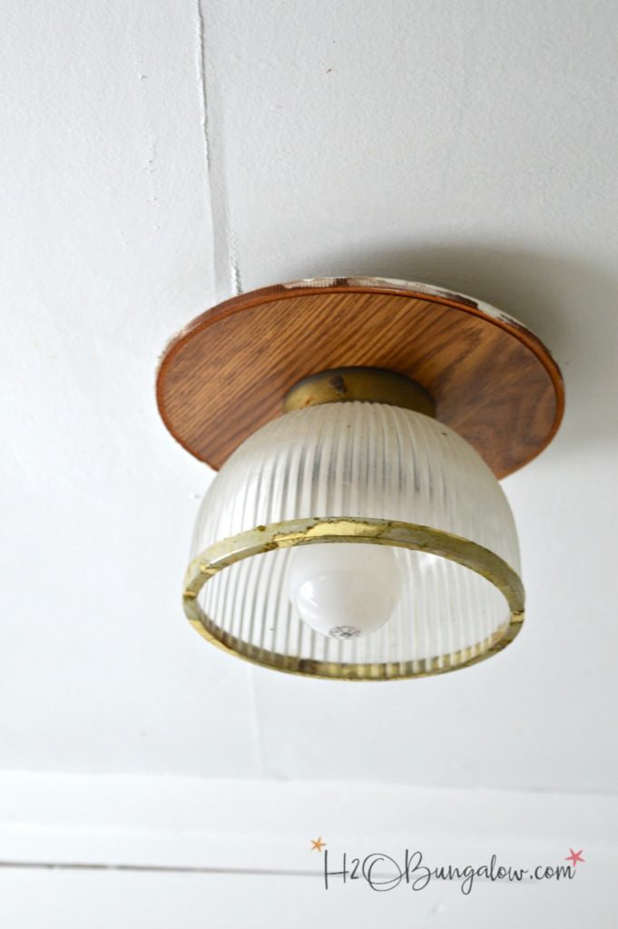 before picture of ceiling light fixture with glass globe and brass accents and would ceiling mount