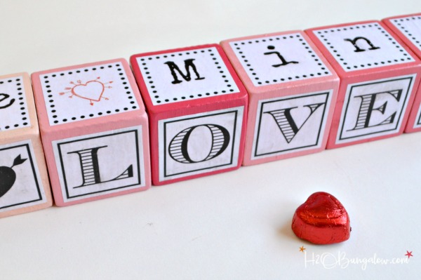Make these DIY Valentine word message blocks with Be Mine, I'm Yours, Kiss Me and more. Free downloadable printable with the words and letters in this post. Plus this post includes over 40 fabulous Valentine crafts and gift tutorials from your favorite bloggers on the web. Romantic and easy gift ideas, fun Valentine crafts for kids and Valentine home decor projects. 