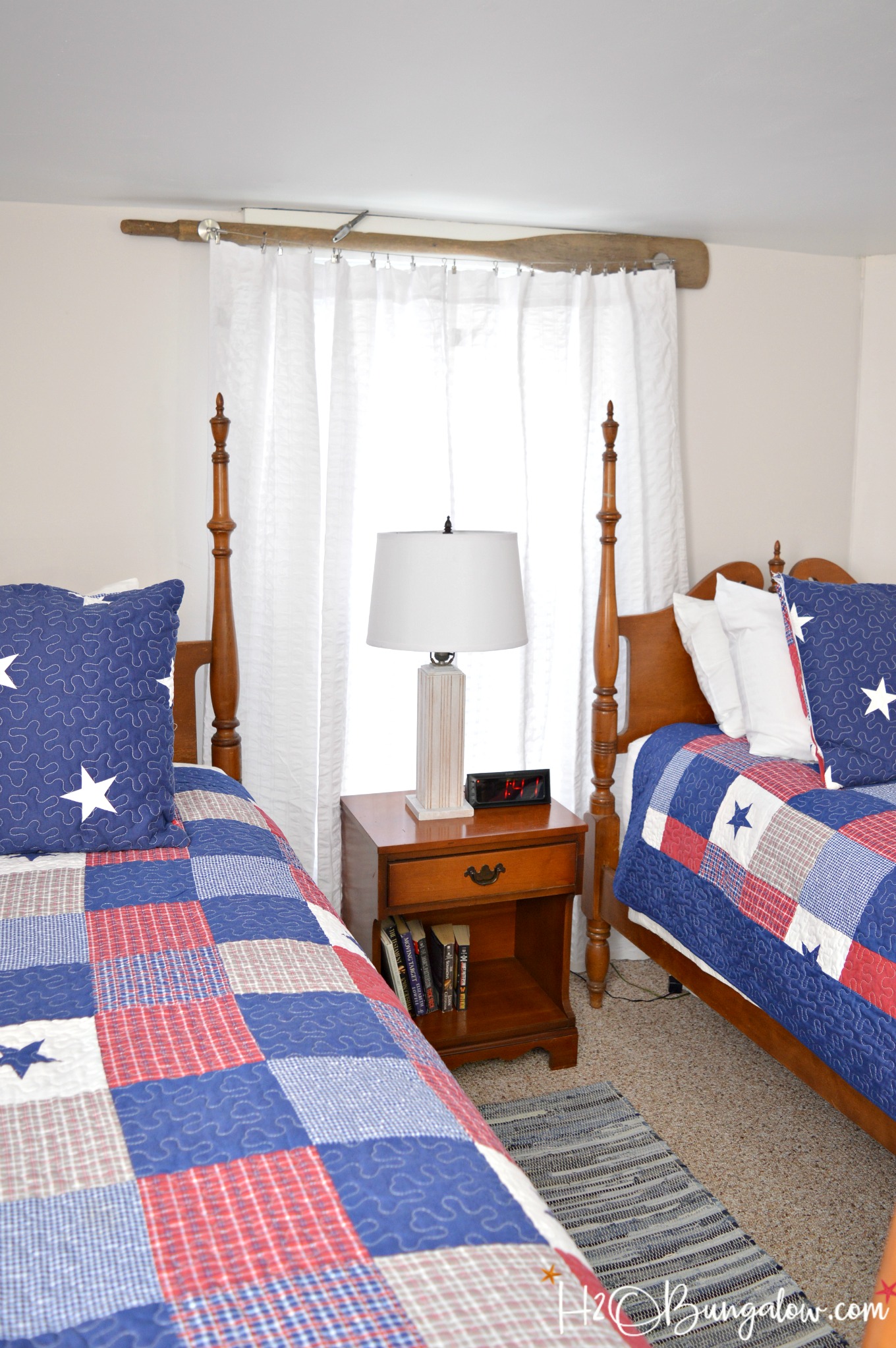 Easy to make DIY vintage oar nautical curtain rod with modern style wire to hold the curtain. See how simple it is to add budget friendly nautical and rustic window decor to a room for instant personality. 