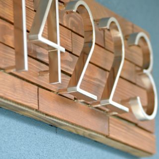 Add instant curb appeal. Easy modern DIY Horizontal Wood Slat Address Plaque Tutorial. Use only a jigsaw, glue and outdoor mounting tape. Drill optional to float letters.