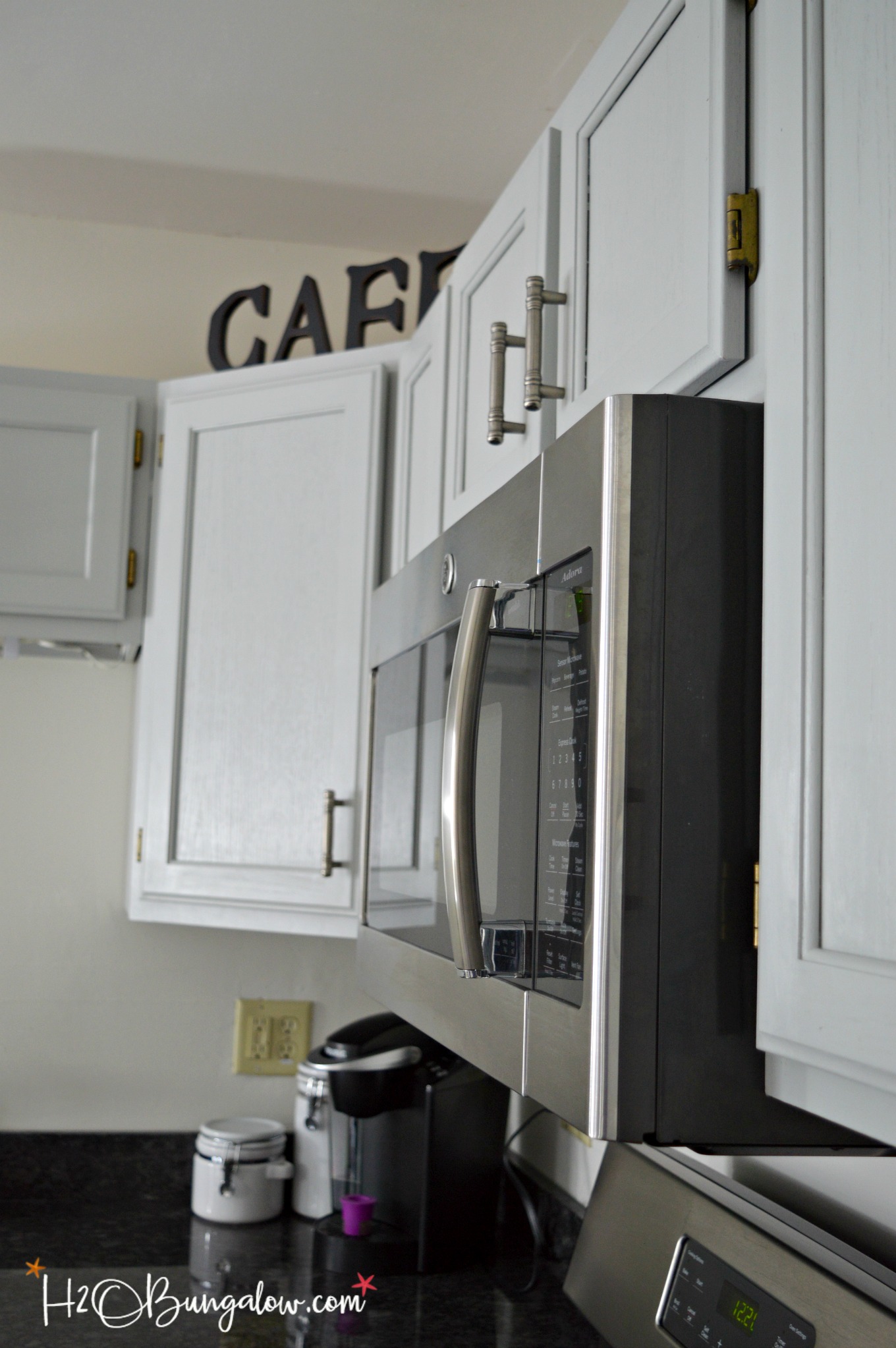 close up of microwave in tutorial for how to paint kitchen cabinets