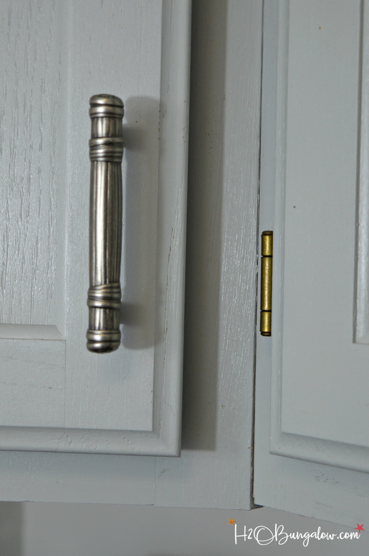 closeup of cabinet hardware in tutorial on how to paint kitchen cabinets
