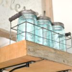 DIY reclaimed wood kitchen shelves made from wood scraps add character and texture to a modern farmhouse. Simple tips for an upscale DIY kitchen project