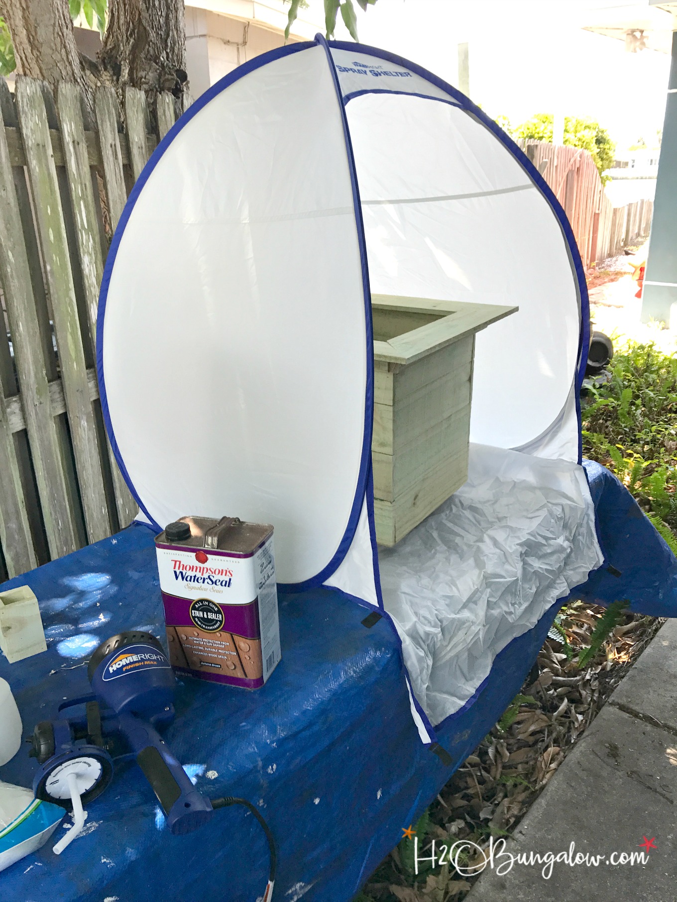 homeright spray shelter and sprayer set up on table with blue tarp and Thompsons water seal's water seal