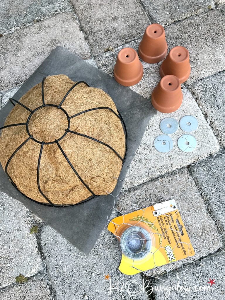 four small clay pits, chicken wire, wire plant basket to make turtle topiary