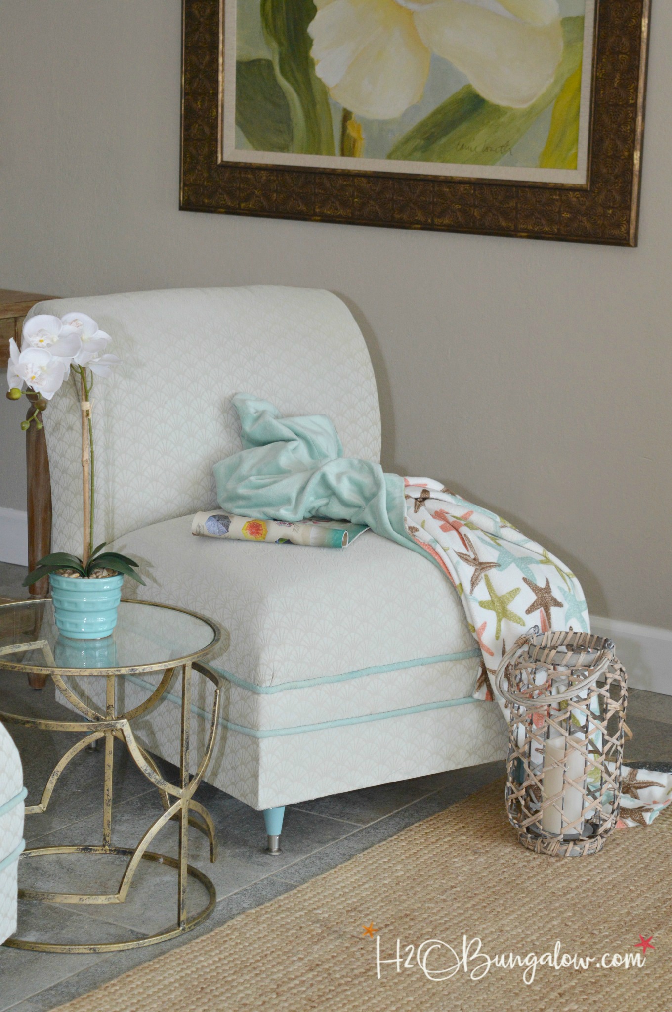 DIY painted upholstered chair makeover tutorial. How to paint a fabric chair with latex paint, add new trim and change the furniture legs for an easy update. Find over 450 home decor DIY tutorials on H2OBungalow.com
