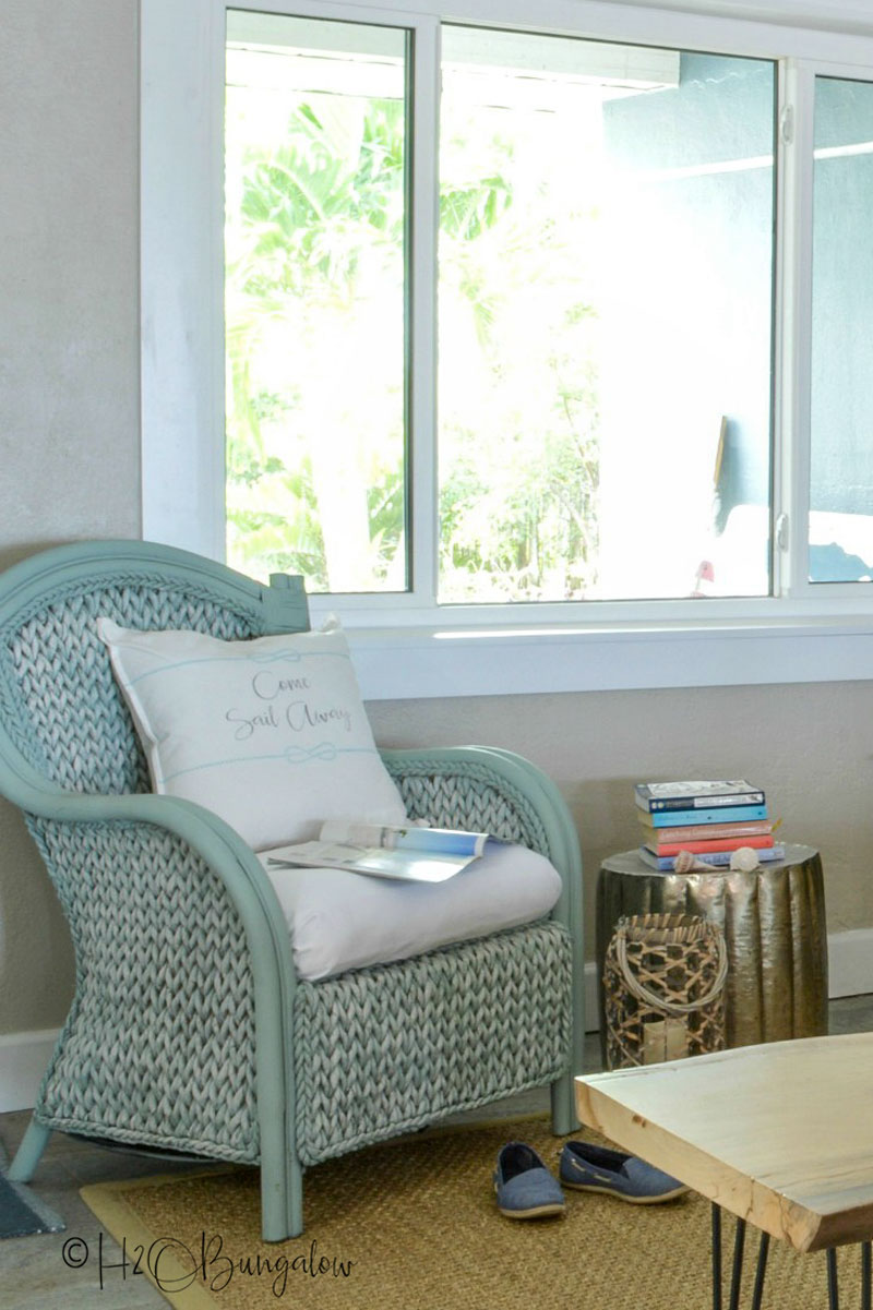 Picture of blue painted wicker chair by window