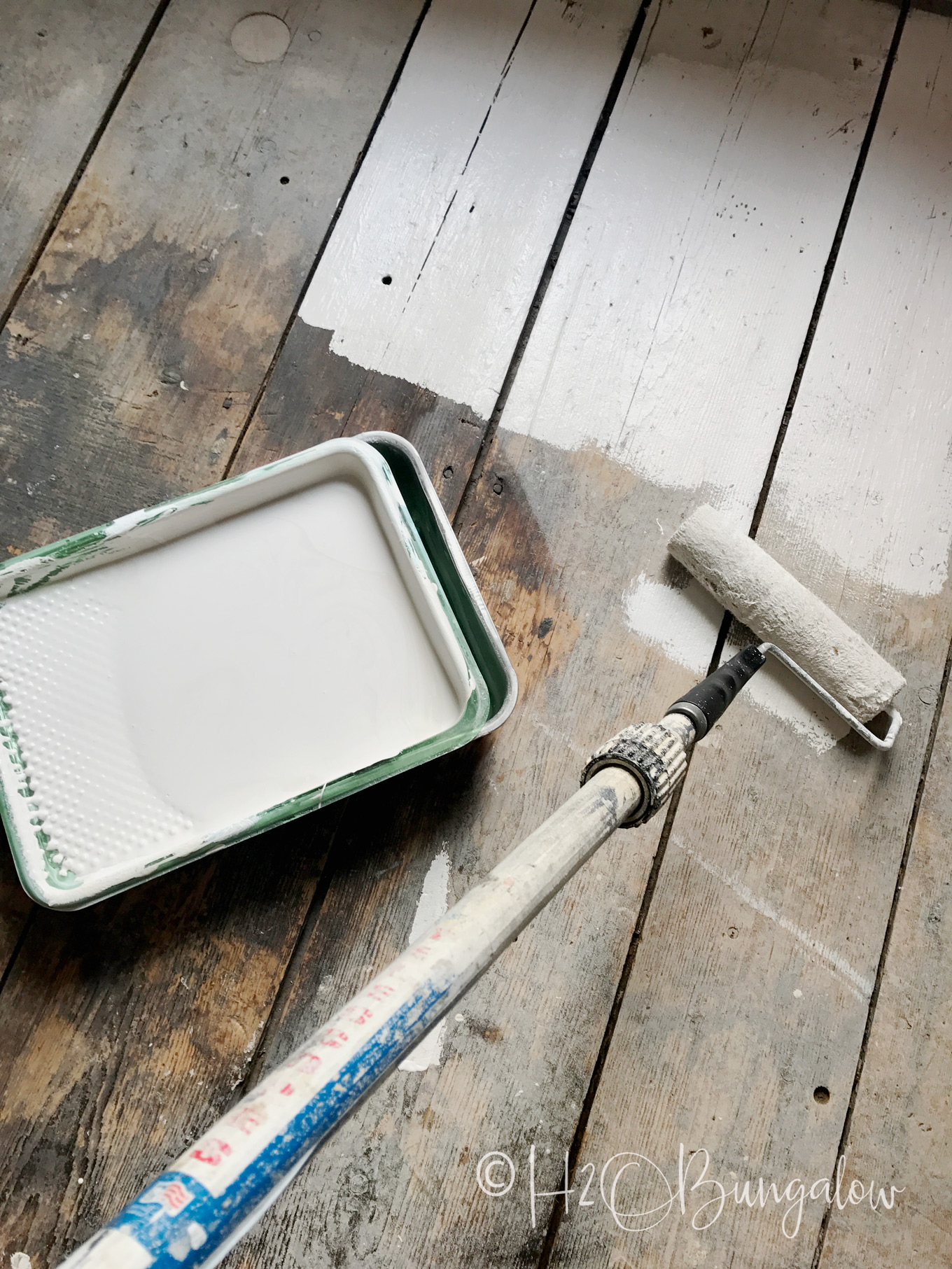 wood floor shown with paint roller