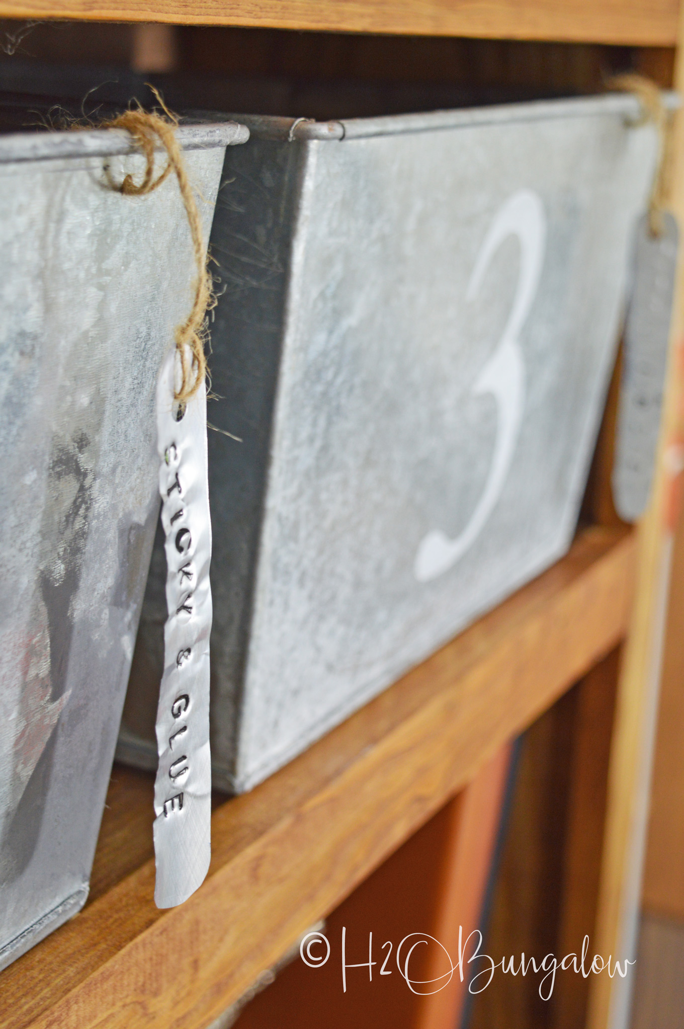 Easy to make soda can stamped metal labels for galvanized bins is a perfect farmhouse or rustic modern style home decor. Try stamping metal labels for home and office organization. One can makes several labels. Make other crafts with metal stamping and soda can metal too. 