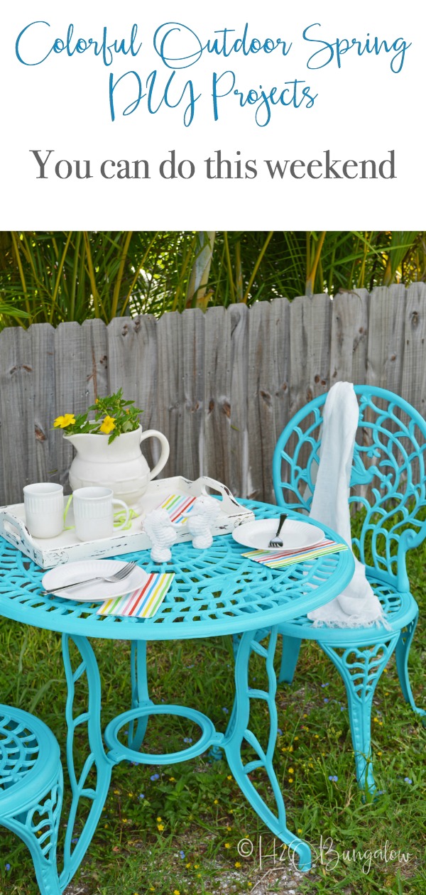 Turquoise outdoor metal bistro table and chairs with place settings 
