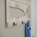 You can easily make a DIY whale coat rack or towel rack for beach towels like mine out of pallets or scrap wood. Follow my instructions for a wood cut-out whale and use your own design to make a sturdy custom coat or towel rack that fits your decor style!