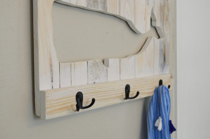 You can easily make a DIY whale coat rack or towel rack for beach towels like mine out of pallets or scrap wood. Follow my instructions for a wood cut-out whale and use your own design to make a sturdy custom coat or towel rack that fits your decor style!