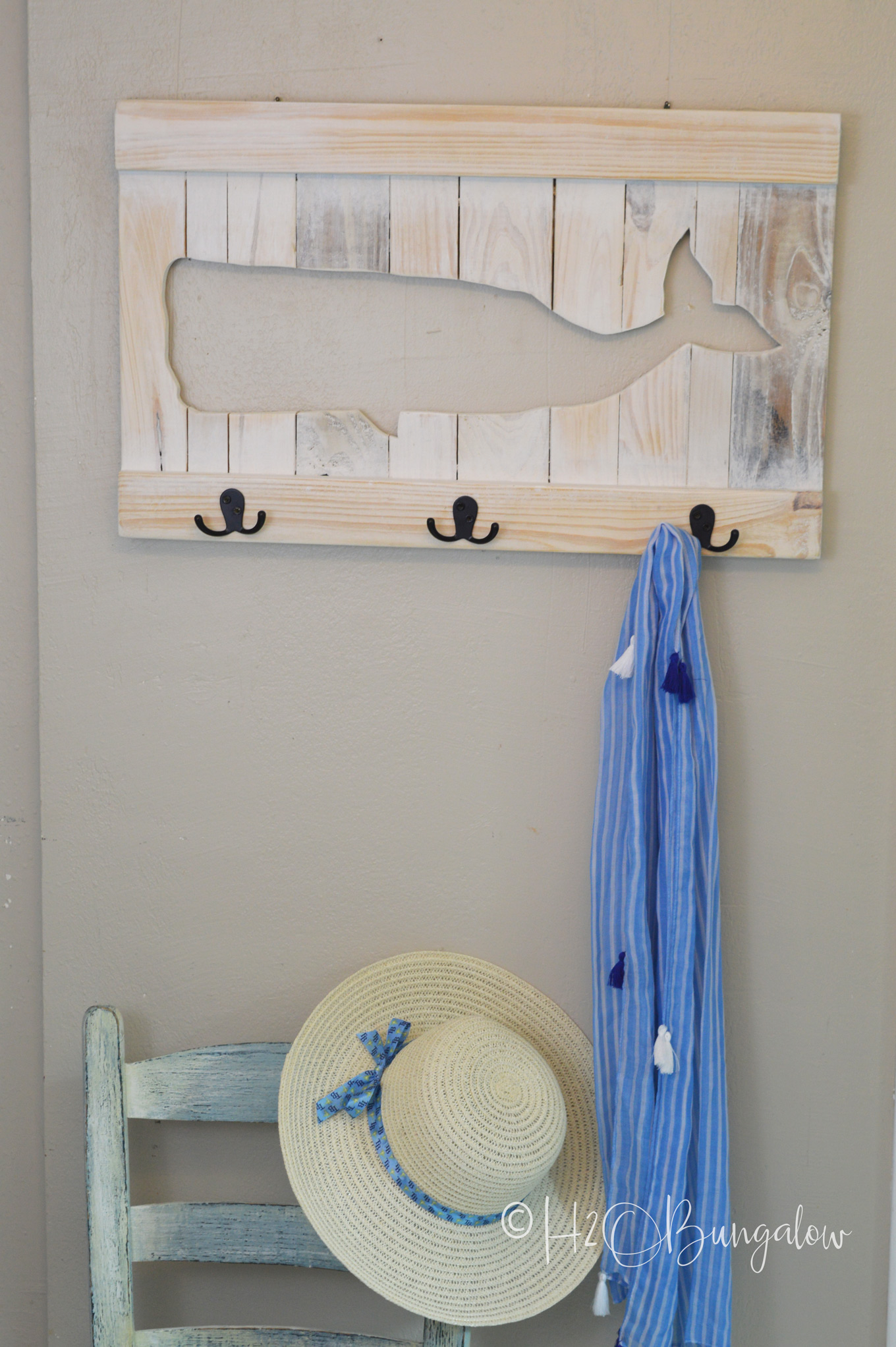 You can easily make a DIY whale coat rack or towel rack for beach towels like mine out of pallets or scrap wood. Follow my instructions for a wood cut-out whale and use your own design to make a sturdy custom coat or towel rack that fits your decor style! 