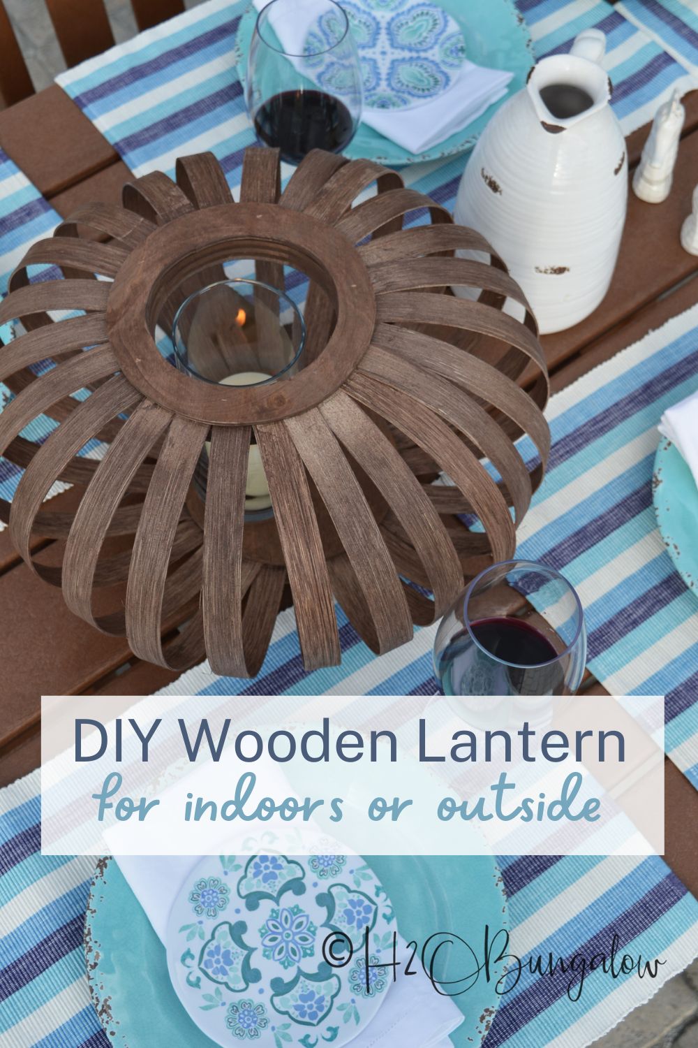DIY wooden lantern on outdoor dining table with candle 